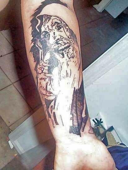 Blackwork forearm tattoo of a sketch-style bearded portrait