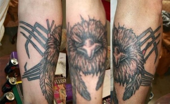 Blackwork forearm tattoo of an owl with geometric accents