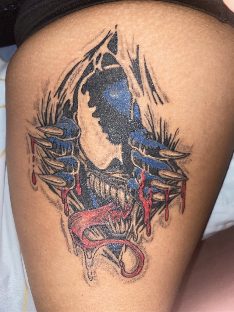 Neo traditional Venom comic character tattoo with bold linework and color accents