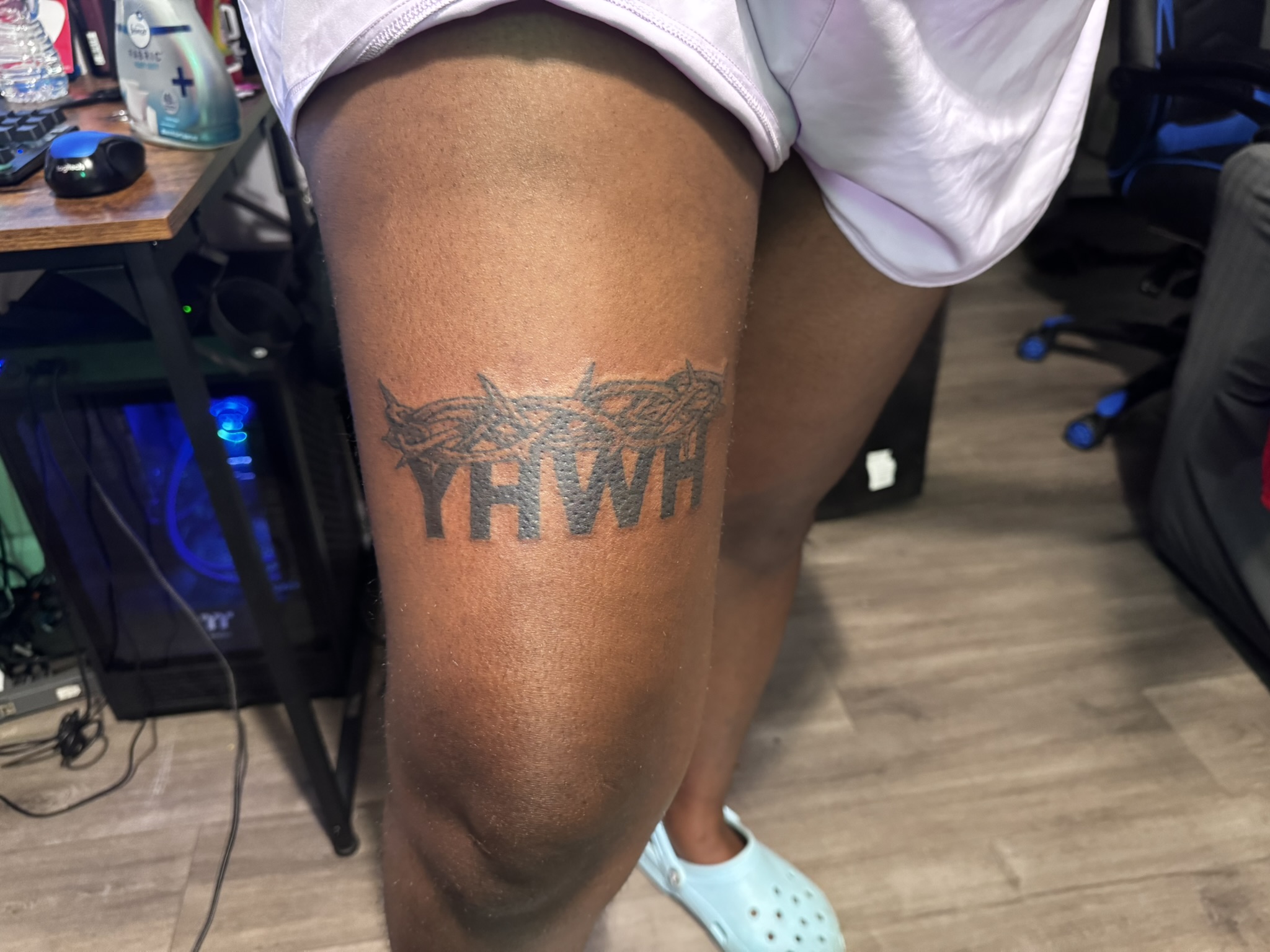 Bold script lettering tattoo on thigh