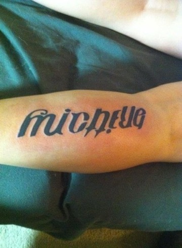 Bold ambigram-style script tattoo of the names Michelle and Brittany