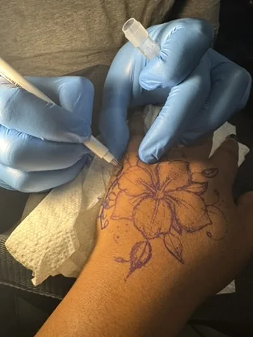 Artist at work tattooing a client